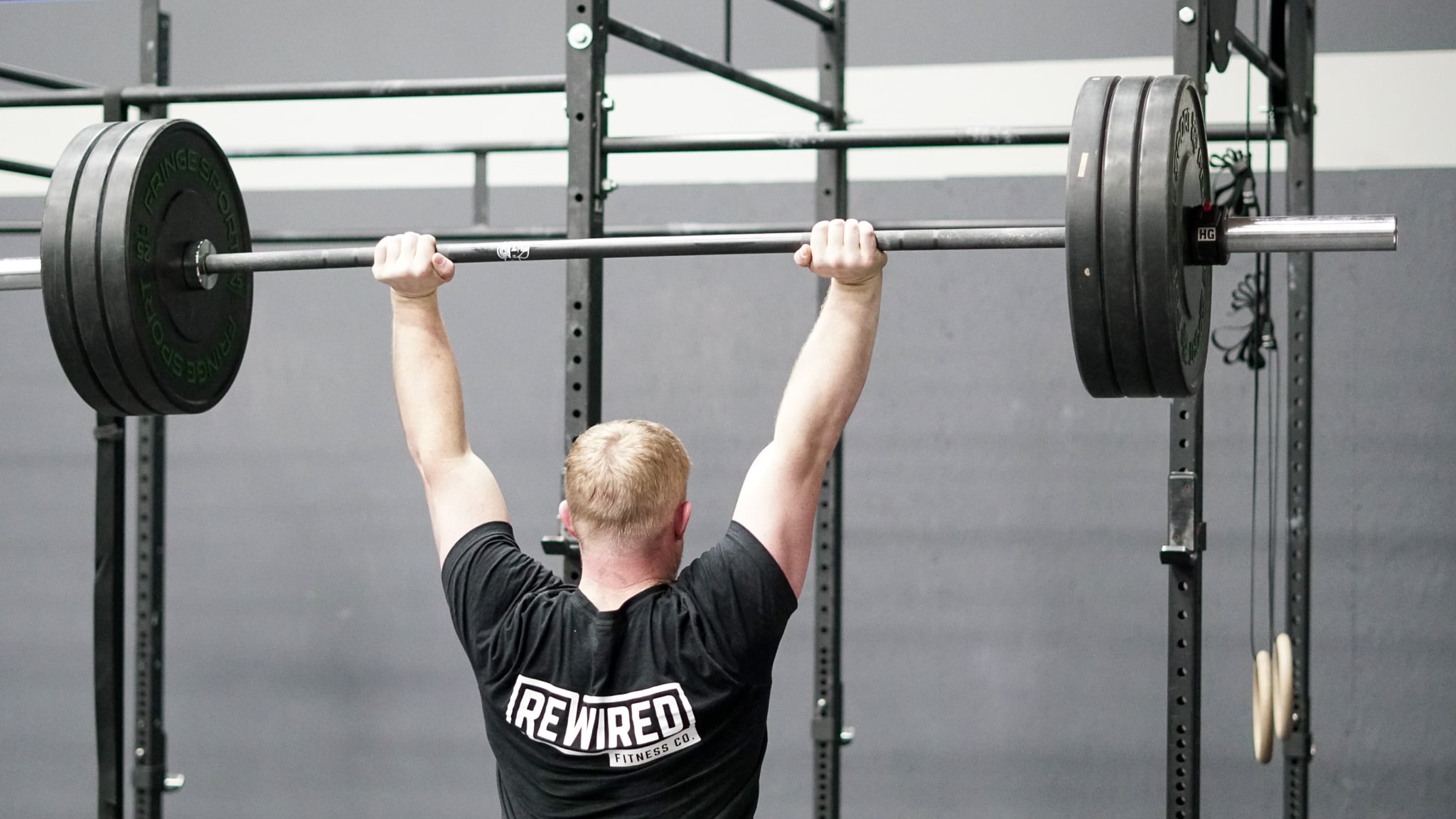 Barbell strength work during a coached class at Rewired Fitness Co.